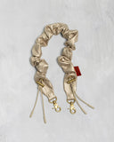 BUNGEE WRIST STRAP (GOLD SYNTHETIC LEATHER) / TOPOLOGIE